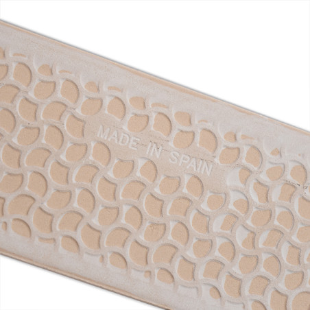 A beige tile features an abstract, leaf-like pattern with the text `MADE IN SPAIN` embossed in the center.