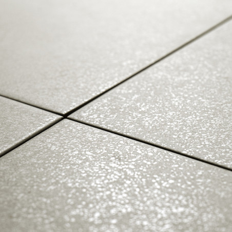 Ceramic tiles, arranged in a grid pattern, are aligned on a flat surface. The tiles have a subtle, textured finish.