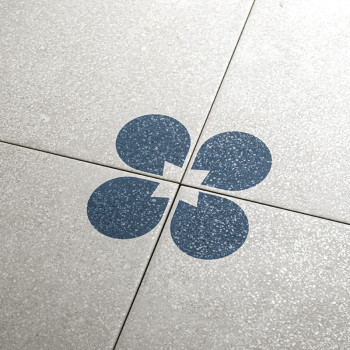 Four light gray tiles, each featuring a quarter of a dark blue circle with a notch, form a complete circular pattern at their in