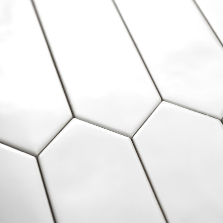 Ladrilhos hexagonais alongados brancos são organizados em um padrão escalonado, criando uma aparência moderna e minimalista em u