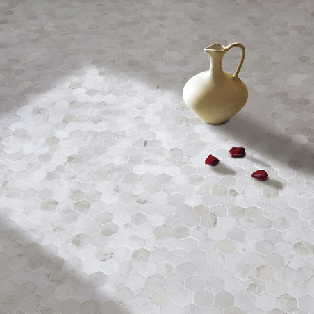 Ceramic pitcher rests on hexagonal stone tiles, illuminated by sunlight, accompanied by scattered red rose petals.