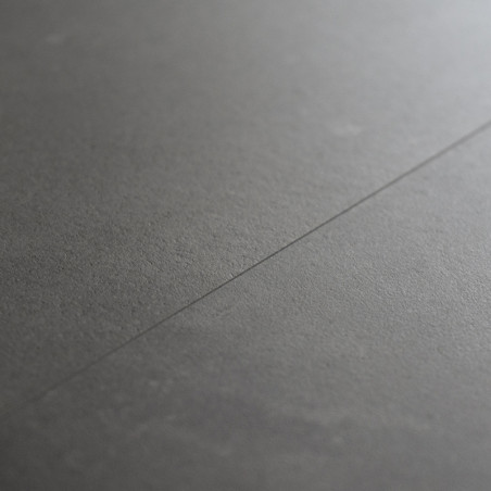 Smooth, dark gray ceramic tile lies flat with a subtle seam running through, creating a minimalist and modern surface appearance