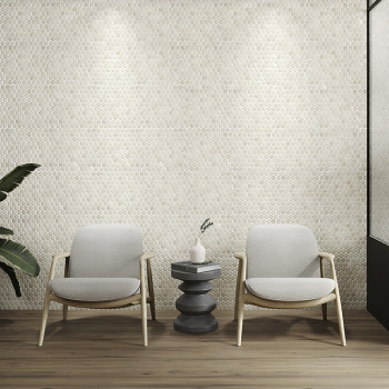 Elegant hexagonal stone tiles form a textured wall, illuminated by spotlights, behind two chairs and a table.