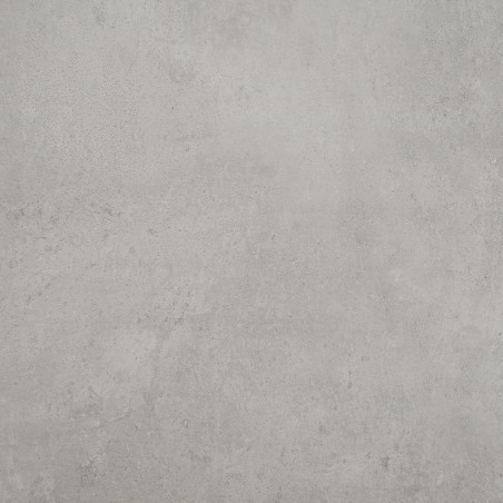 Um azulejo cinza claro de textura lisa fica plano, mostrando leves manchas e variações sutis de tom, sugerindo um ambiente inter
