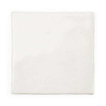 A square white tile sits stationary, presenting a smooth, slightly textured surface. The plain background emphasizes its minimal