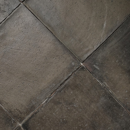 Terracotta tiles form a weathered, earthy pattern, with subtle texture variations, fit tightly together in a dense mosaic arrang