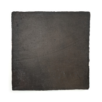 Square terracotta tile rests alone against a plain white background, appearing smooth and dark with subtle texture variations.