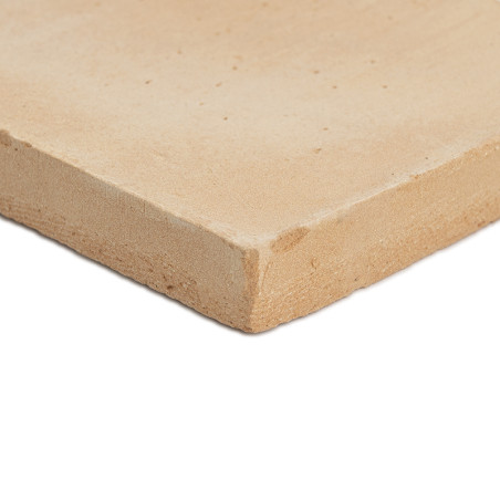 A smooth, square terracotta tile with slightly rounded edges rests on a plain white surface, capturing natural texture.
