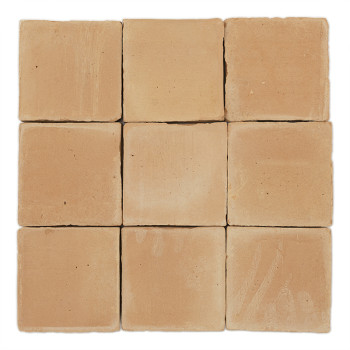 A plain, square terracotta tile lies flat against a neutral, white background, showing its smooth, earthy-colored surface.