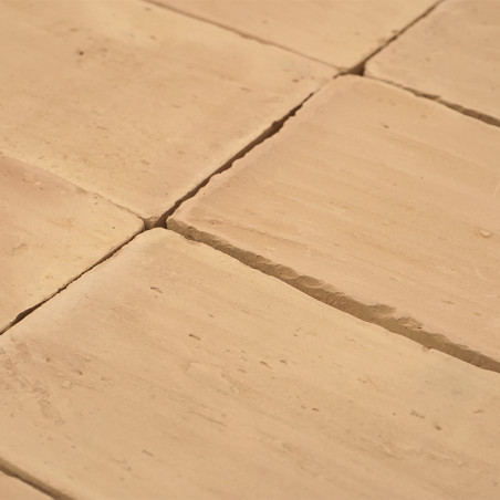 Terracotta tiles laid evenly, creating a smooth, textured surface with subtle variations. arranged neatly in a grid pattern.