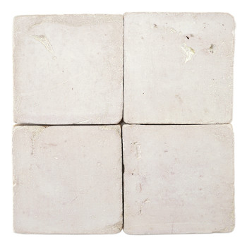 Four square terracotta tiles resting together, displaying subtle texture variations, against a plain white background.