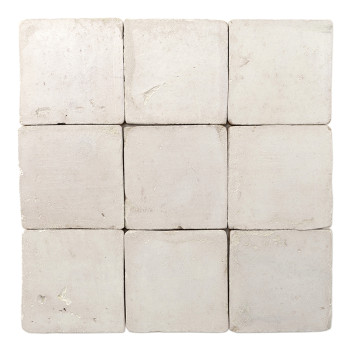 Square terracotta tile appears textured, resting against a plain white background, showcasing its rough, uneven surface.