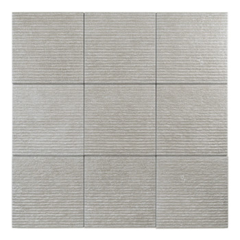 A square, light gray tile displays a textured surface and horizontal grooves, set against a plain, neutral backdrop.