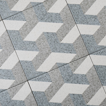 Les carreaux gris et blancs forment un motif géométrique en zigzag imbriqué, créant un effet visuellement dynamique dans un déco
