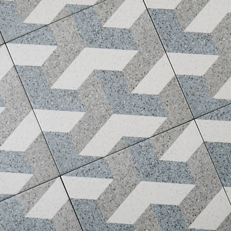 Les carreaux gris et blancs forment un motif géométrique en zigzag imbriqué, créant un effet visuellement dynamique dans un déco