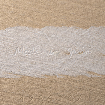 The tile features embossed text reading `Made in Spain` and numbers `1 2 3 4 5 6 7` on a textured beige surface.