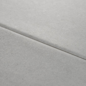 Two adjacent gray tiles lie flat, creating a subtle seam across the center. The smooth surface suggests a clean, modern setting.